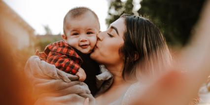 mom kissing baby